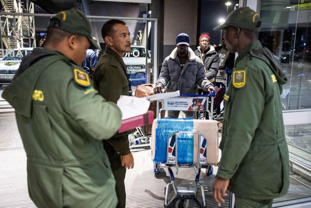 South African Border Management Authority officials control a Nigerian nationals documents at the OR Tambo International Airport, in Johannesburg, on June 10, 2026, as the a first group of Nigerian nationals gets ready to board an evacuation flight for Lagos. The first batch of Nigerian nationals board an Air Peace Airlines evacuation flight chartered by the Federal Government of Nigeria, departing for Lagos amid a wave of xenophobic attacks in South Africa. Hundreds of anti-migrant protesters marched through a township outside Johannesburg on June 8, 2026, a day after South African President Cyril Ramaphosa pledged action against groups accused of fuelling xenophobic violence. South Africa has seen recurring bouts of anti-migrant violence, with protests intensifying this year after vigilante groups ordered undocumented foreigners to leave by June 30. (Photo by EMMANUEL CROSET / AFP)