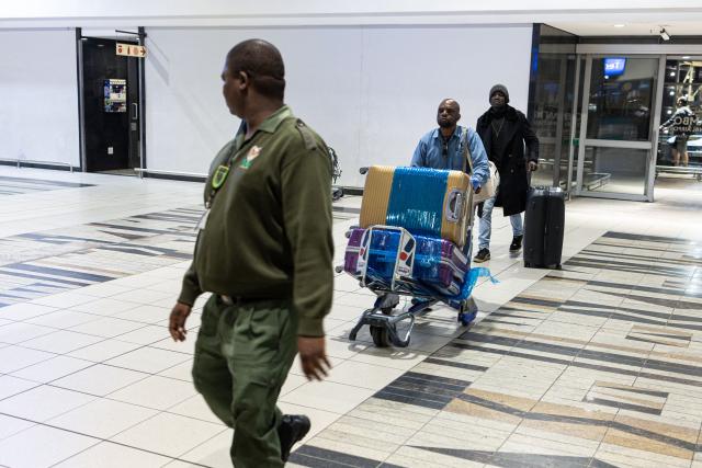 A South African Border Management Authority official directs Nigerian nationals towards the check in desk at the OR Tambo International Airport in Johannesburg on June 10, 2026 as the a first group of Nigerian nationals gets ready to board an evacuation flight for Lagos. The first batch of Nigerian nationals board an Air Peace Airlines evacuation flight chartered by the Federal Government of Nigeria, departing for Lagos amid a wave of xenophobic attacks in South Africa. Hundreds of anti-migrant protesters marched through a township outside Johannesburg on June 8, 2026, a day after South African President Cyril Ramaphosa pledged action against groups accused of fuelling xenophobic violence. South Africa has seen recurring bouts of anti-migrant violence, with protests intensifying this year after vigilante groups ordered undocumented foreigners to leave by June 30. (Photo by EMMANUEL CROSET / AFP)