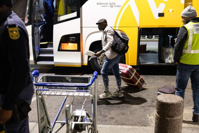 A Nigerian national, who will be part of the first evacuation flight for Lagos, gets off a bus at the OR Tambo International Airport, in Johannesburg on June 10, 2026. The first batch of Nigerian nationals board an Air Peace Airlines evacuation flight chartered by the Federal Government of Nigeria, departing for Lagos amid a wave of xenophobic attacks in South Africa. Hundreds of anti-migrant protesters marched through a township outside Johannesburg on June 8, 2026, a day after South African President Cyril Ramaphosa pledged action against groups accused of fuelling xenophobic violence. South Africa has seen recurring bouts of anti-migrant violence, with protests intensifying this year after vigilante groups ordered undocumented foreigners to leave by June 30. (Photo by EMMANUEL CROSET / AFP)
