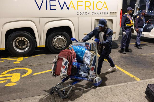 A Nigerian national, who will be part of the first evacuation flight for Lagos, gets off a bus at the OR Tambo International Airport, in Johannesburg on June 10, 2026. The first batch of Nigerian nationals board an Air Peace Airlines evacuation flight chartered by the Federal Government of Nigeria, departing for Lagos amid a wave of xenophobic attacks in South Africa. Hundreds of anti-migrant protesters marched through a township outside Johannesburg on June 8, 2026, a day after South African President Cyril Ramaphosa pledged action against groups accused of fuelling xenophobic violence. South Africa has seen recurring bouts of anti-migrant violence, with protests intensifying this year after vigilante groups ordered undocumented foreigners to leave by June 30. (Photo by EMMANUEL CROSET / AFP)