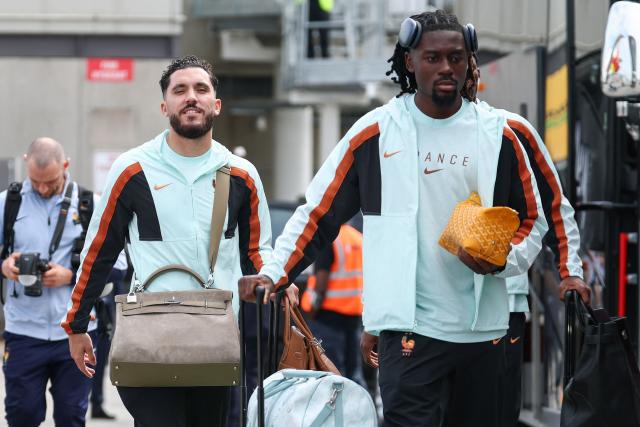 France's forward #24 Rayan Cherki (L) and midfielder #08 Manu Kone arrive at Logan Aeropuerto Internacional in Boston, Massachusetts on June 10 2026, ahead of the FIFA 2026 World Cup football tournament. (Photo by Franck FIFE / AFP)