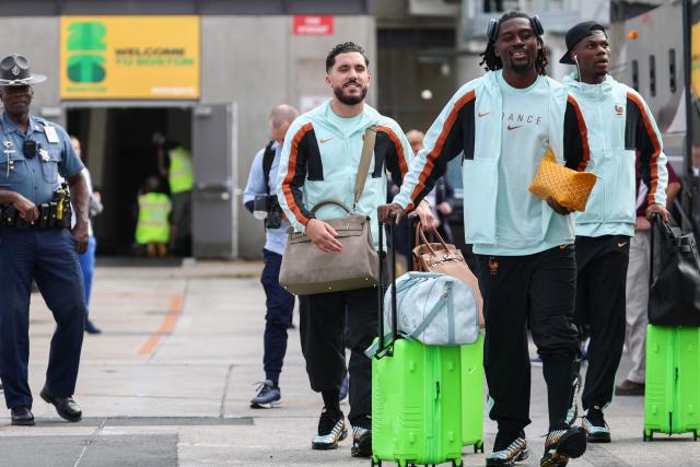 France's forward #24 Rayan Cherki (L), midfielder #08 Manu Kone (C), and midfielder #08 Aurelien Tchouameni arrive at Logan Aeropuerto Internacional in Boston, Massachusetts on June 10 2026, ahead of the FIFA 2026 World Cup football tournament. (Photo by Franck FIFE / AFP)
