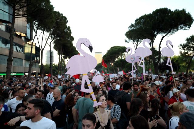 Protestors hold cartoon flamingos as they gather in front of the Albanian Prime Minister's Office to demonstrate against the construction on the southern coast of Albania a luxury resort near a protected natural area, in Tirana, on June 10, 2026. Several thousand citizens have demonstrated in Tirana for more than a week to demand transparency around a tourist complex project allegedly linked to US President's son-in-law, Jared Kushner. The demonstrators argue that the estimated $1.2 billion project, led by Kushner and his wife Ivanka, will harm the environment, with plans for luxury hotels in the protected area of Vjosa-Narta on the southern coast. (Photo by Adnan Beci / AFP)