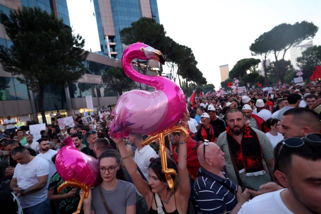 Protestors hold inflatable flamingos as they gather in front of the Albanian Prime Minister's Office to demonstrate against the construction on the southern coast of Albania of a luxury resort near a protected natural area, in Tirana, on June 10, 2026. Several thousand citizens have demonstrated in Tirana for more than a week to demand transparency around a tourist complex project allegedly linked to US President's son-in-law, Jared Kushner. The demonstrators argue that the estimated $1.2 billion project, led by Kushner and his wife Ivanka, will harm the environment, with plans for luxury hotels in the protected area of Vjosa-Narta on the southern coast. (Photo by Adnan Beci / AFP)