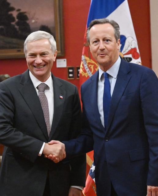 Britain's former Prime Minister David Cameron (R) shakes hands with Chile's President Jose Antonio Kast during a meeting at the La Moneda palace in Santiago on June 10, 2026. (Photo by Rodrigo ARANGUA / AFP)