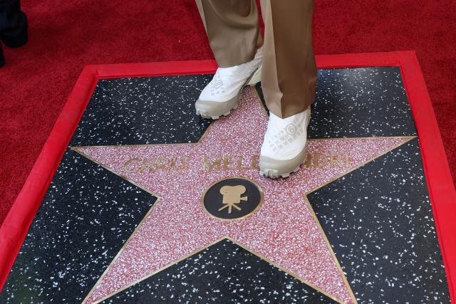 Illumination founder and CEO Chris Meledandri's shoes are seen as he stands on his newly unveiled star during his Hollywood Walk of Fame star ceremony in Hollywood, California, on June 10, 2026. (Photo by VALERIE MACON / AFP)