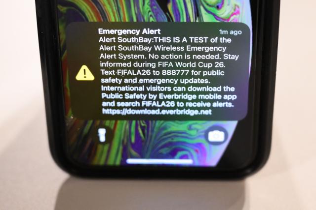 A test of the wireless Emergency Alert System (EAS) is displayed on a smart phone at Los Angeles Stadium (temporarily renamed from SoFi Stadium) ahead of the 2026 FIFA World Cup in Inglewood, California on June 10, 2026. (Photo by Patrick T. Fallon / AFP)