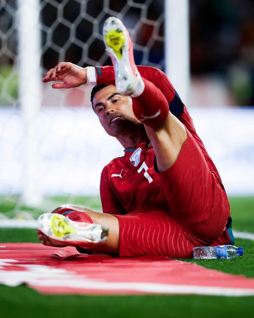 Portugal's forward #07 Cristiano Ronaldo falls down to the ground during the international friendly football match between Portugal and Nigeria at Magalhaes Pessoa Stadium in Leiria, on June 10, 2026. (Photo by FILIPE AMORIM / AFP)