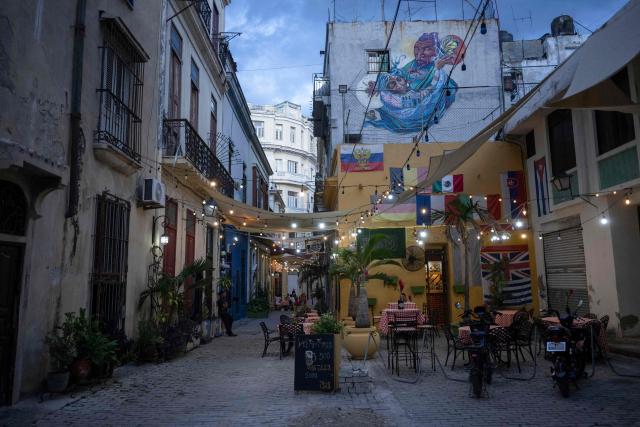 Empty tables at a restaurant in Old Havana are seen amid a lack of tourists in Havana on June 9, 2026. The United Nations High Commissioner for Human Rights on June 8, 2026, urged the United States to "immediately" lift the sanctions that have been accumulating against Cuba since January. "Fuel restrictions imposed since early 2026 and the recent tightening of extraterritorial sanctions are directly harming Cubans, particularly the most vulnerable," Volker Turk said in a statement. (Photo by Pablo PORCIUNCULA / AFP)