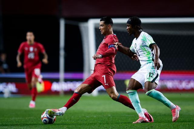 Portugal's forward #07 Cristiano Ronaldo fights for the ball with Nigeria's defender #13 Bruno Onyemaechi during the international friendly football match between Portugal and Nigeria at Magalhaes Pessoa Stadium in Leiria, on June 10, 2026. (Photo by FILIPE AMORIM / AFP)