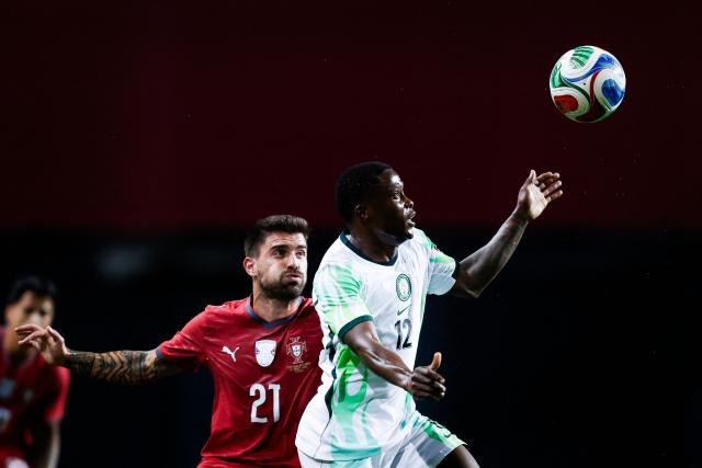 Portugal's midfielder #21 Ruben Neves fights for the ball with Nigeria's midfielder #12 Tochukwu Nadi during the international friendly football match between Portugal and Nigeria at Magalhaes Pessoa Stadium in Leiria, on June 10, 2026. (Photo by FILIPE AMORIM / AFP)
