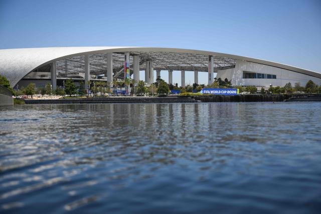 Los Angeles Stadium (temporarily renamed from SoFi Stadium) stands across Lake Park ahead of the 2026 FIFA World Cup in Inglewood, California on June 10, 2026. (Photo by Patrick T. Fallon / AFP)