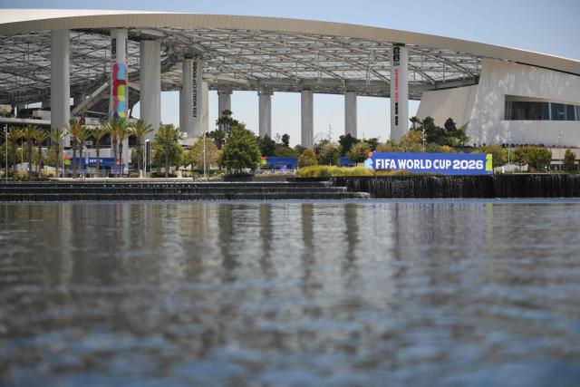 Los Angeles Stadium (temporarily renamed from SoFi Stadium) stands across Lake Park ahead of the 2026 FIFA World Cup in Inglewood, California on June 10, 2026. (Photo by Patrick T. Fallon / AFP)