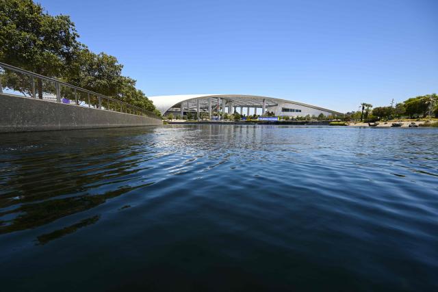 Los Angeles Stadium (temporarily renamed from SoFi Stadium) stands across Lake Park ahead of the 2026 FIFA World Cup in Inglewood, California on June 10, 2026. (Photo by Patrick T. Fallon / AFP)