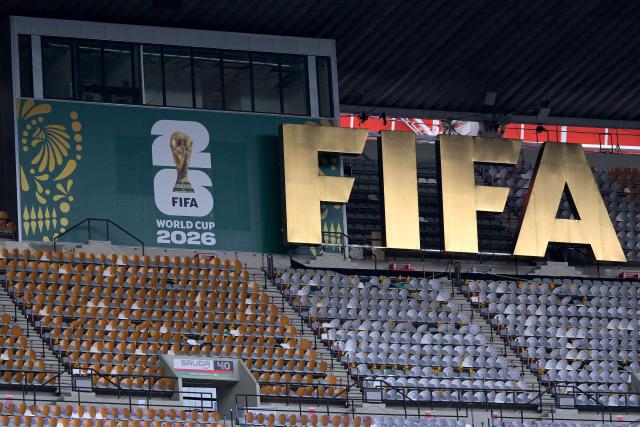 A FIFA logo is pictured on the stands as South Africa's players take part in a pitch recognition at the Mexico City Stadium in Mexico City on June 10, 2026, on the eve of the 2026 World Cup football match between Mexico and South Africa. (Photo by Alfredo ESTRELLA / AFP)