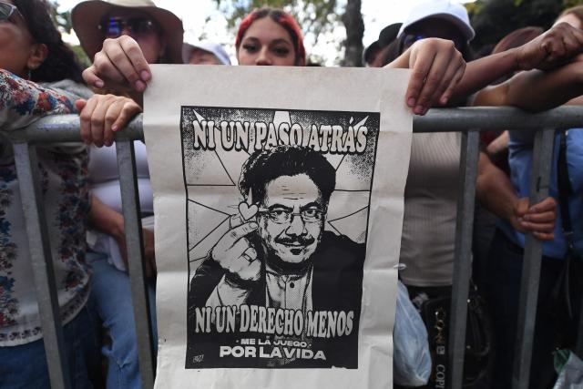 Supporters of Colombia's presidential candidate for the Pacto Historico party, Ivan Cepeda, hold a poster of him reading "Not a step back, not a right less" during a campaign rally in Medellin, Colombia on June 10, 2026. Colombia will hold the runoff presidential election on June 21. (Photo by Jaime SALDARRIAGA / AFP)