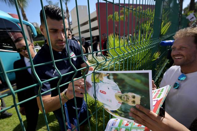 Iran's forward Mehdi Taremi signs autographs for fans outside the Marriott Hotel before leaving for a training session in Tijuana, Mexico, on June 10, 2026, ahead of the 2026 FIFA World Cup football tournament. (Photo by Guillermo Arias / AFP)