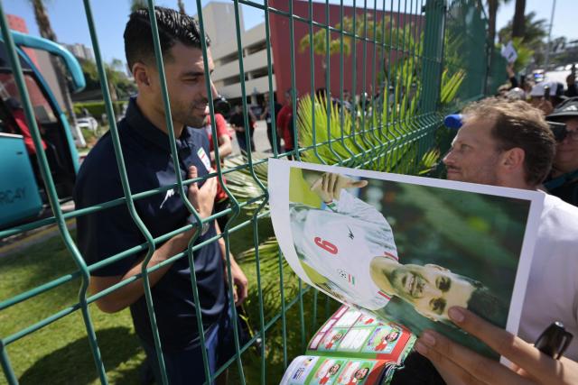 Iran's forward Mehdi Taremi gestures as he signs autographs for fans outside the Marriott Hotel before leaving for a training session in Tijuana, Mexico, on June 10, 2026, ahead of the 2026 FIFA World Cup football tournament. (Photo by Guillermo Arias / AFP)