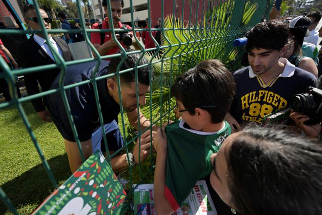 Iran's forward Mehdi Taremi signs autographs for fans outside the Marriott Hotel before leaving for a training session in Tijuana, Mexico, on June 10, 2026, ahead of the 2026 FIFA World Cup football tournament. (Photo by Guillermo Arias / AFP)