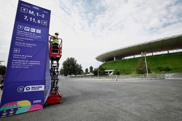 Workers set up informational banners outside the Guadalajara Stadium in Zapopan, Mexico on June 10, 2026, on the eve of the 2026 World Cup football match between South Korea and the Czech Republic. (Photo by Ulises Ruiz / AFP)