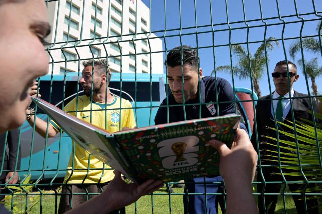 Iran's forward Mehdi Taremi signs autographs for a fan outside the Marriott Hotel before leaving for a training session in Tijuana, Mexico, on June 10, 2026, ahead of the 2026 FIFA World Cup football tournament. (Photo by Guillermo Arias / AFP)