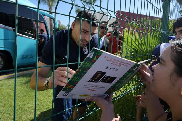 Iran's forward Mehdi Taremi signs autographs for a fan outside the Marriott Hotel before leaving for a training session in Tijuana, Mexico, on June 10, 2026, ahead of the 2026 FIFA World Cup football tournament. (Photo by Guillermo Arias / AFP)