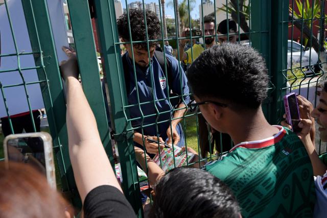 Iran's defender Danial Iri signs autographs for fans outside the Marriott Hotel before leaving for a training session in Tijuana, Mexico, on June 10, 2026, ahead of the 2026 FIFA World Cup football tournament. (Photo by Guillermo Arias / AFP)