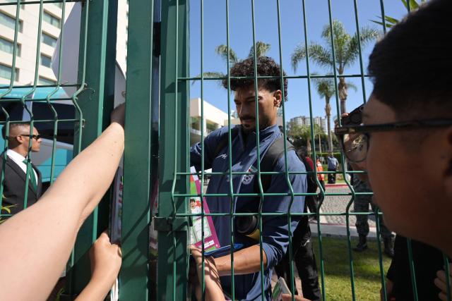 Iran's defender Danial Iri signs autographs for fans outside the Marriott Hotel before leaving for a training session in Tijuana, Mexico, on June 10, 2026, ahead of the 2026 FIFA World Cup football tournament. (Photo by Guillermo Arias / AFP)
