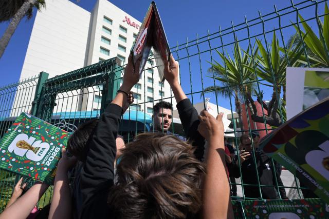 Iran's midfielder  Saeid Ezatolahi signs autographs for fans outside the Marriott Hotel before leaving for a training session in Tijuana, Mexico, on June 10, 2026, ahead of the 2026 FIFA World Cup football tournament. (Photo by Guillermo Arias / AFP)