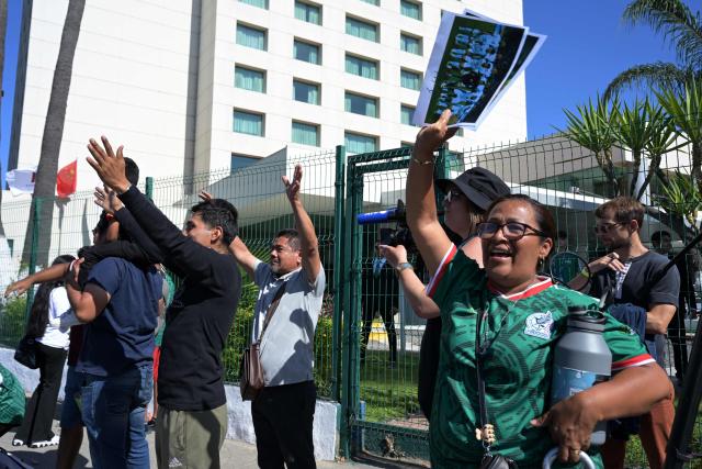 Fans wave to the Iranian national football team players outside the Marriott Hotel as they leave for a training session in Tijuana, Mexico, on June 10, 2026, ahead of the 2026 FIFA World Cup football tournament. (Photo by Guillermo Arias / AFP)