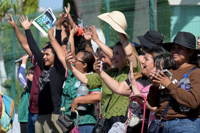 Fans wave to the Iranian national football team players outside the Marriott Hotel as they leave for a training session in Tijuana, Mexico, on June 10, 2026, ahead of the 2026 FIFA World Cup football tournament. (Photo by Guillermo Arias / AFP)
