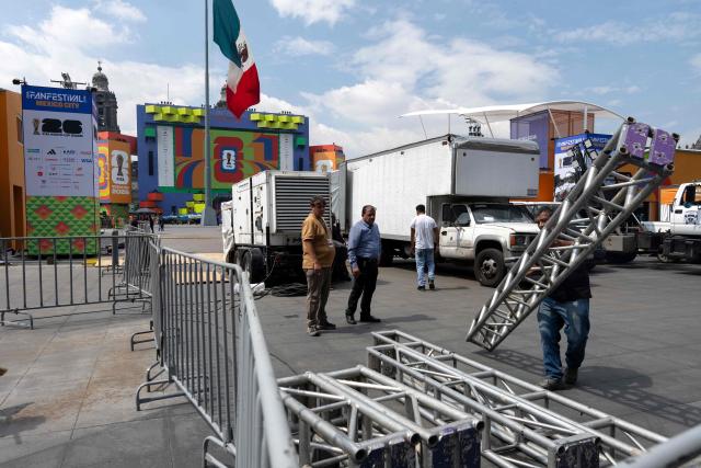 Workers set up the FIFA Fan Fest installations at Zocalo Square, one day before the opening of the 2026 FIFA World Cup football tournament in Mexico City on June 10, 2026. (Photo by Gerardo Luna / AFP)