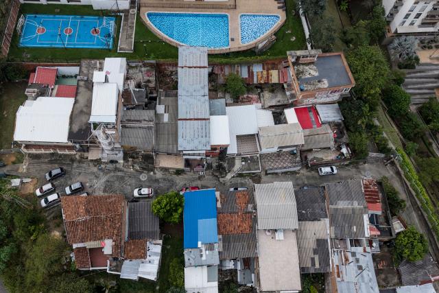 Aerial view of the Siloe and Cristales neighbourhoods in the western region of Cali, Coolombia on June 10, 2026. (Photo by JOAQUIN SARMIENTO / AFP)