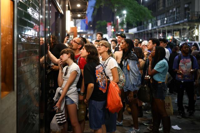 New York Knicks fans watch the game live through the windows of a bar outside Madison Square Garden during Game 4 of the NBA Finals between the New York Knicks and the San Antonio Spurs in New York on June 10, 2026. (Photo by CHARLY TRIBALLEAU / AFP)