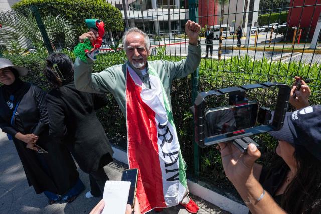 Iranian fan Mostafa Pourmand gestures during an interview with media outside the Iran's base camp at the Marriott Hotel in Tijuana, Mexico on June 9, 2026, ahead of the 2026 World Cup football tournament. (Photo by Guillermo ARIAS / AFP)
