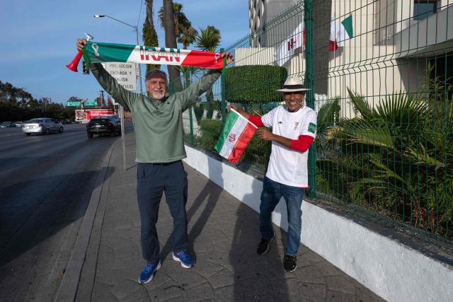 Iranian fans Mostafa Pourmand (L) and Reza Mansoor (R) pose for a photo outside the Iran's base camp at the Marriott Hotel in Tijuana, Mexico on June 9, 2026, ahead of the 2026 World Cup football tournament. (Photo by Guillermo ARIAS / AFP)