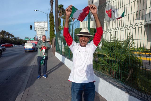 Iranian fans Mostafa Pourmand (L) and Reza Mansoor (R) pose for a photo outside the Iran's base camp at the Marriott Hotel in Tijuana, Mexico on June 9, 2026, ahead of the 2026 World Cup football tournament. (Photo by Guillermo ARIAS / AFP)