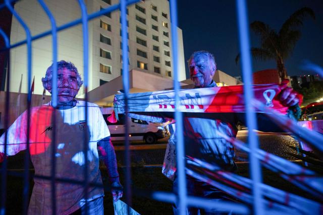 Iranian fans Reza Mansoor (L) and Mostafa Pourmand (R) pose for a photo outside the Iran's base camp at the Marriott Hotel in Tijuana, Mexico on June 9, 2026, ahead of the 2026 World Cup football tournament. (Photo by Guillermo ARIAS / AFP)