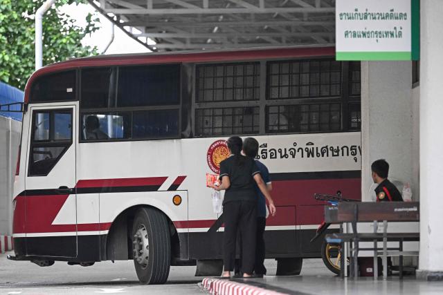 A police vehicle believed to be transporting bombing suspects Bilal Mohammed and Yusufu Mieraili arrives at the Bangkok South Criminal Court in Bangkok on June 11, 2026, ahead of the verdict for the Erawan Shrine bombing that took place on August 17, 2015. A Thai court will deliver its verdict on June 11 in the long-delayed case of a 2015 attack at a Bangkok shrine that killed 20 people, the deadliest bombing in the country's history. Two Uyghur men, Yusufu Mieraili and Bilal Mohammed, stand accused of planting a bomb at a Hindu shrine in Bangkok's commercial heart in August 2015. The defendants have denied the charges. (Photo by Lillian SUWANRUMPHA / AFP)