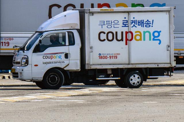 (FILES) A worker drives a delivery truck of South Korean e-commerce giant Coupang in Seoul on December 9, 2025. South Korea imposed on June 11, 2026 a record $408 million fine on e-commerce giant Coupang over a leak that exposed the data of more than 30 million customers and provoked tensions with the United States, where the company is incorporated. (Photo by ANTHONY WALLACE / AFP)