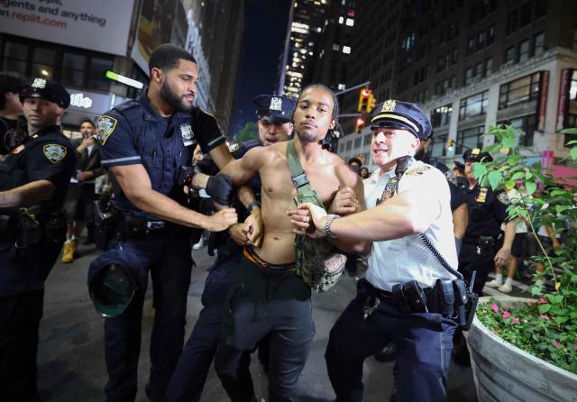 NYPD officers detain a man after clashes outside Madison Square Garden, where New York Knicks fans gather during Game 4 of the NBA Finals between the New York Knicks and the San Antonio Spurs in New York on June 10, 2026. (Photo by CHARLY TRIBALLEAU / AFP)