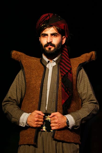A Kurdish man presents a traditional outfit during the 4th (Shal Shabek), Kurdish costume festival in the city of Zakho, in Iraq's northern autonomous Kurdistan region on June 10, 2026. (Photo by Safin HAMID / AFP)
