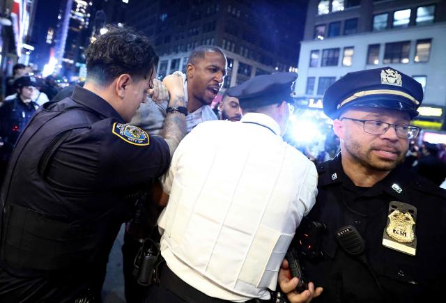NYPD officers detain a man after clashes outside Madison Square Garden, where New York Knicks fans gather during Game 4 of the NBA Finals between the New York Knicks and the San Antonio Spurs in New York on June 10, 2026. (Photo by CHARLY TRIBALLEAU / AFP)