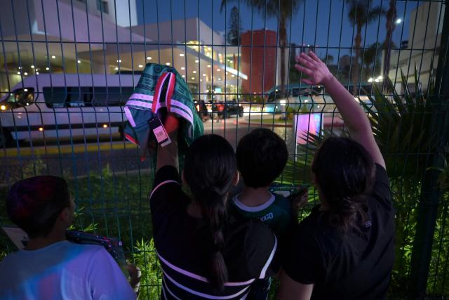 Fans wave to the bus carrying Iran's players as it arrives at the Marriott Hotel after a training session in Tijuana, Mexico, on June 10, 2026, ahead of the 2026 FIFA World Cup football tournament. (Photo by Guillermo Arias / AFP)