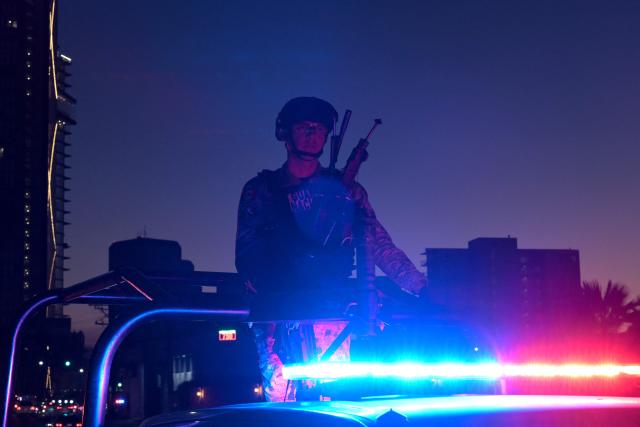 A Mexican National Guard officer escorts the bus carrying Iran's players as it arrives at the Marriott Hotel after a training session in Tijuana, Mexico, on June 10, 2026, ahead of the 2026 FIFA World Cup football tournament. (Photo by Guillermo Arias / AFP)