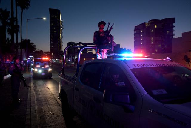 Mexican National Guard officers escort the bus carrying Iran's players as it arrives at the Marriott Hotel after a training session in Tijuana, Mexico, on June 10, 2026, ahead of the 2026 FIFA World Cup football tournament. (Photo by Guillermo Arias / AFP)
