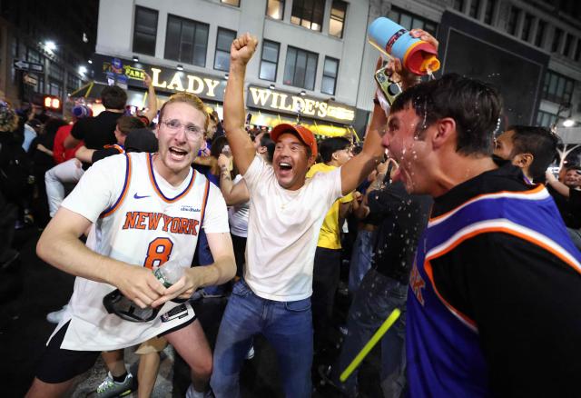 New York Knicks fans celebrate outside Madison Square Garden after their team’s Game 4 victory over the San Antonio Spurs in the NBA Finals in New York on June 10, 2026. (Photo by CHARLY TRIBALLEAU / AFP)