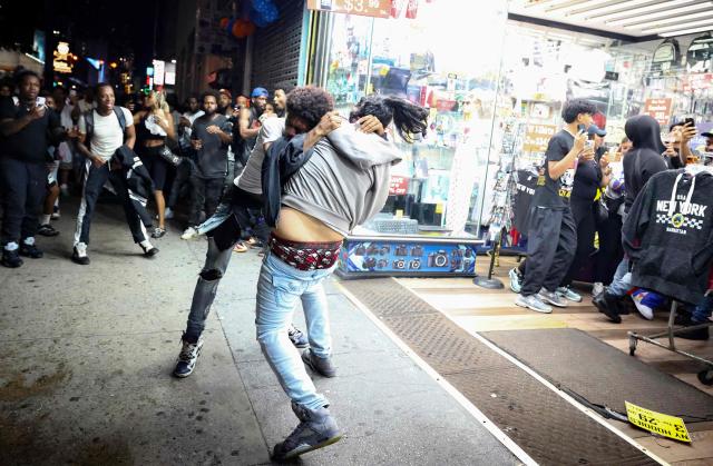 People fight in the street as New York Knicks fans celebrate after their team’s Game 4 victory over the San Antonio Spurs in the NBA Finals in New York on June 10, 2026. (Photo by CHARLY TRIBALLEAU / AFP)