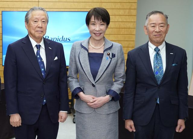 Japan's Prime Minister Sanae Takaichi (C) receives a courtesy call from Japan's semiconductor manufacturing company Rapidus Corp. Chairman Tetsuro Higashi (L) and President Atsuyoshi Koike (R) at the Prime Minister's Office in Tokyo on June 11, 2026. (Photo by JIJI PRESS / AFP) / Japan OUT