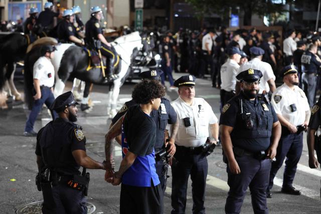 NYPD detain a man after New York Knicks victory celebrations turned disorderly following the team’s Game 4 win over the San Antonio Spurs in the NBA Finals in New York on June 10, 2026. (Photo by CHARLY TRIBALLEAU / AFP)